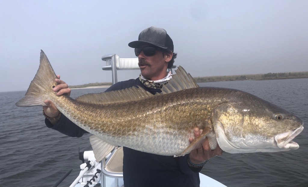 LA Fly Guide, Captain Paul Lappin holding a Louisiana Red Fish he just caught