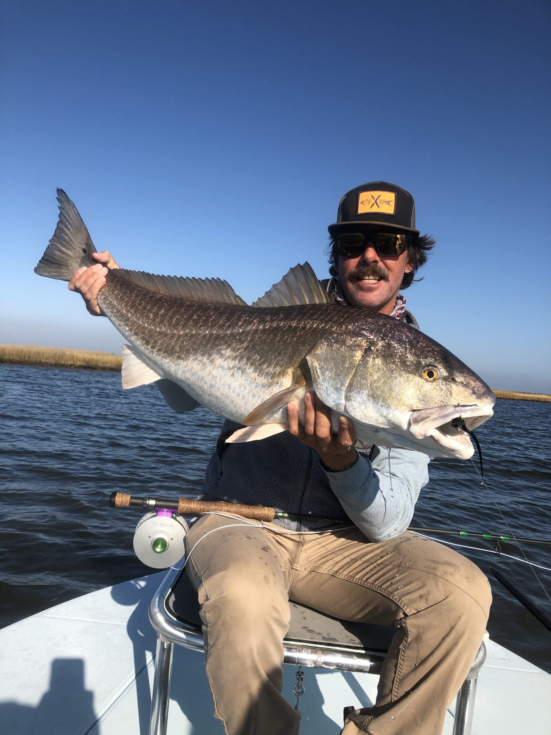 Captain Paul Out on the water with a Louisiana Red Fish he caught.